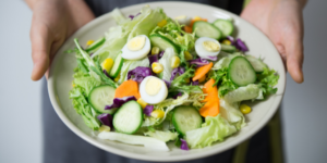 Lady holding a bowl of salad